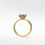 Side profile of the Lily Engagement Ring in yellow gold, showing the brilliant diamond held in a delicate petal claw setting.