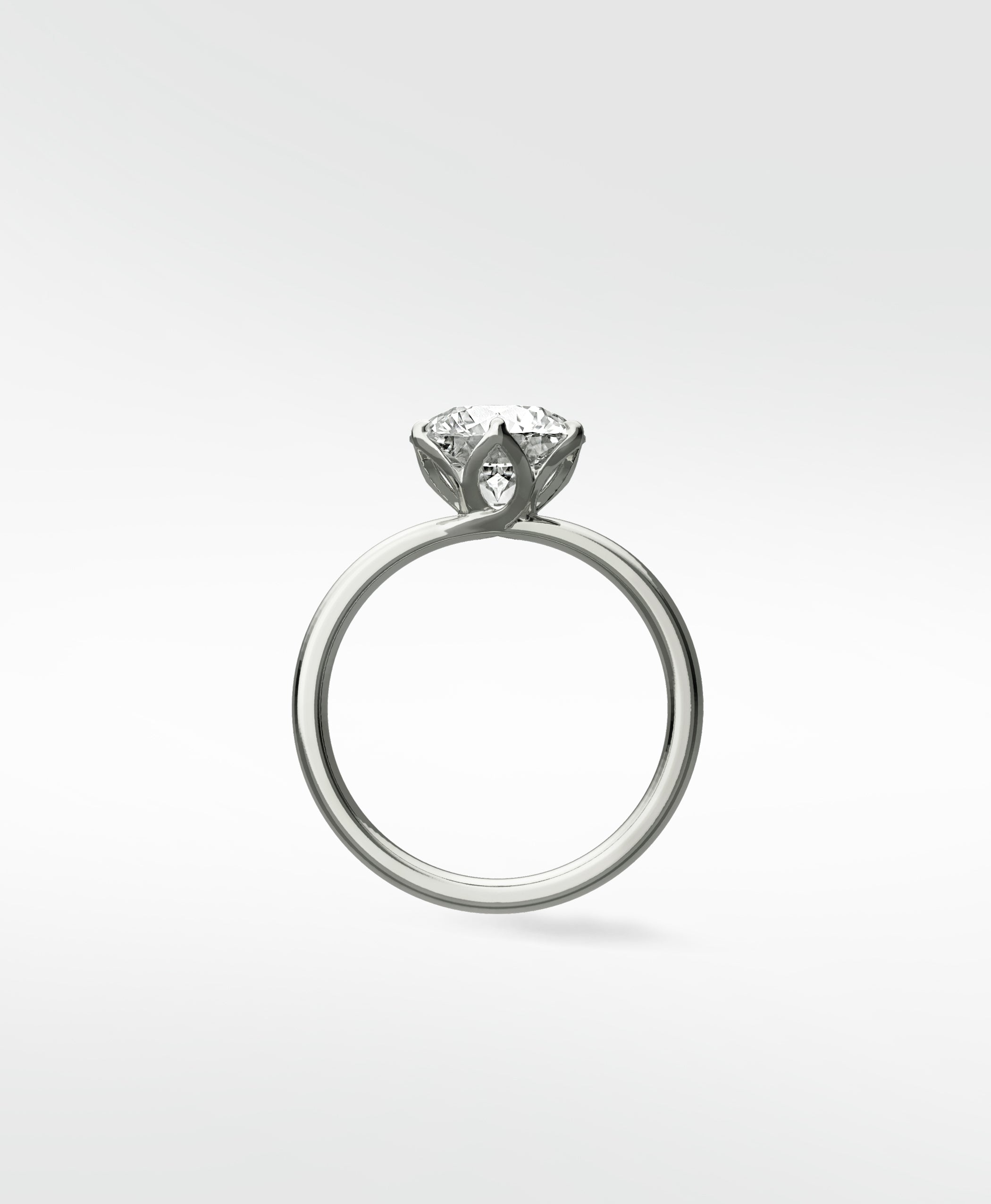 Lily Engagement Ring in white gold, shown in profile, with a solitaire diamond held in an elegant petal claw setting.