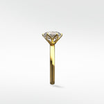 Side profile of the Lily Engagement Ring in yellow gold, featuring its unique petal claw diamond setting.