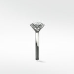 Side profile of the Lily Engagement Ring with a round diamond held in its signature petal claw setting.