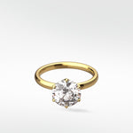 Lily Engagement Ring in yellow gold with a round brilliant diamond in a six-prong petal claw setting.