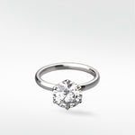 Lily Engagement Ring with a round solitaire diamond in a six-prong petal claw setting on a white gold band.