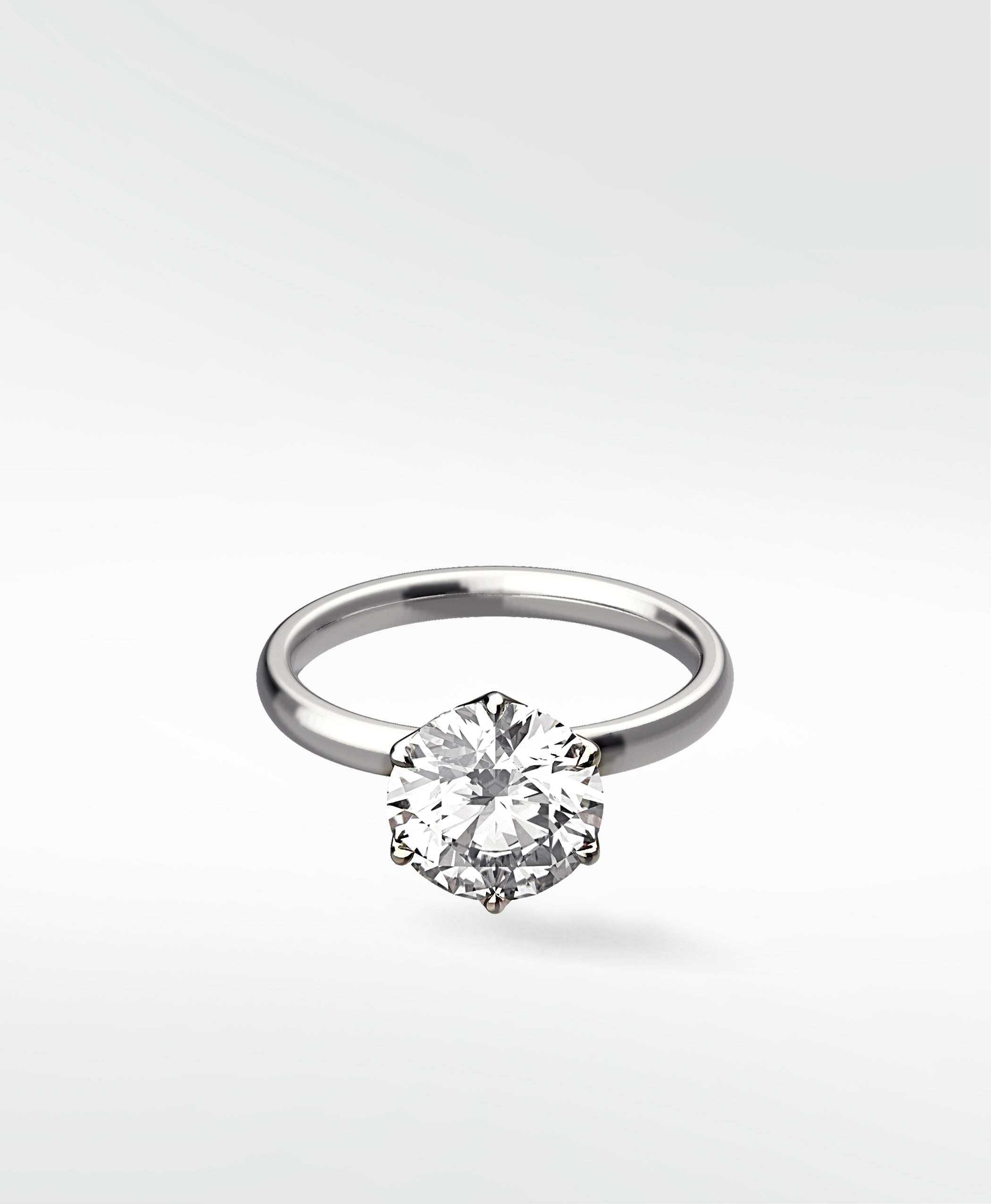 Lily Engagement Ring with a round solitaire diamond in a six-prong petal claw setting on a white gold band.
