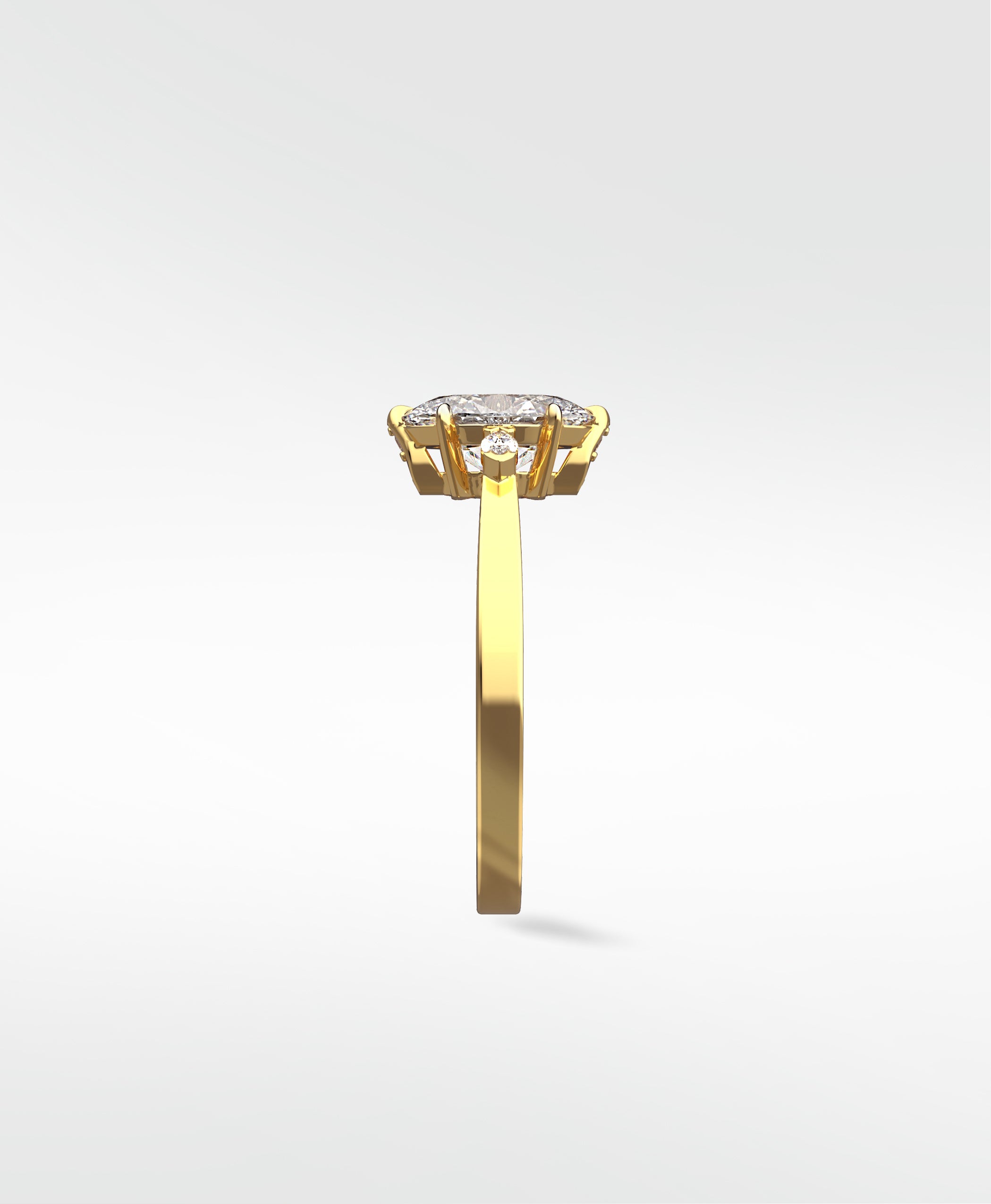 Side profile of the Fern Engagement Ring in yellow gold, showcasing its oval center diamond and marquise accent stones.