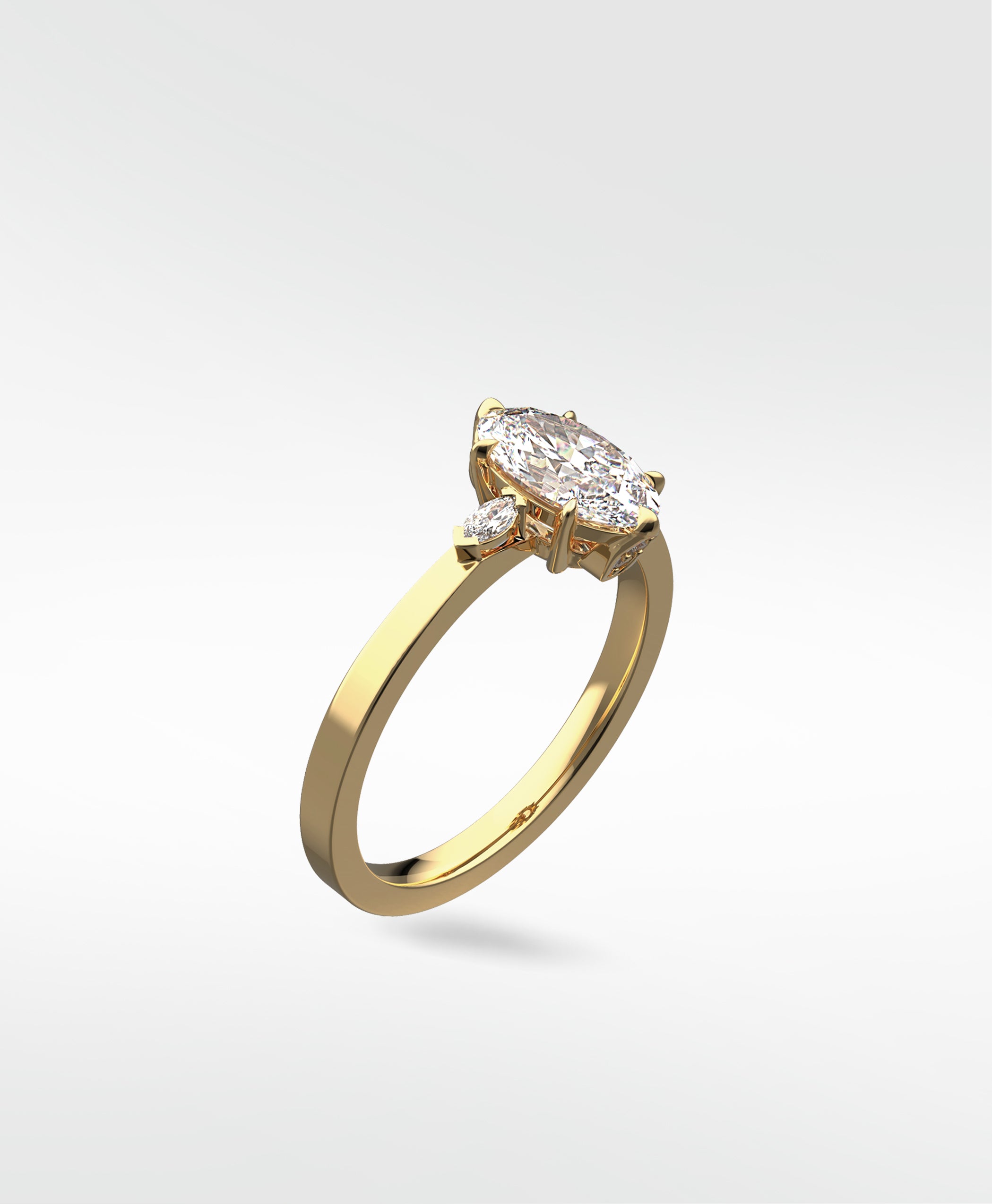 The Lark & Berry Fern Engagement Ring in yellow gold, featuring a marquise-cut center diamond and two side accent diamonds.