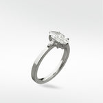 A three-stone Fern Engagement Ring featuring a marquise-cut diamond flanked by two smaller marquise diamonds on a platinum band.