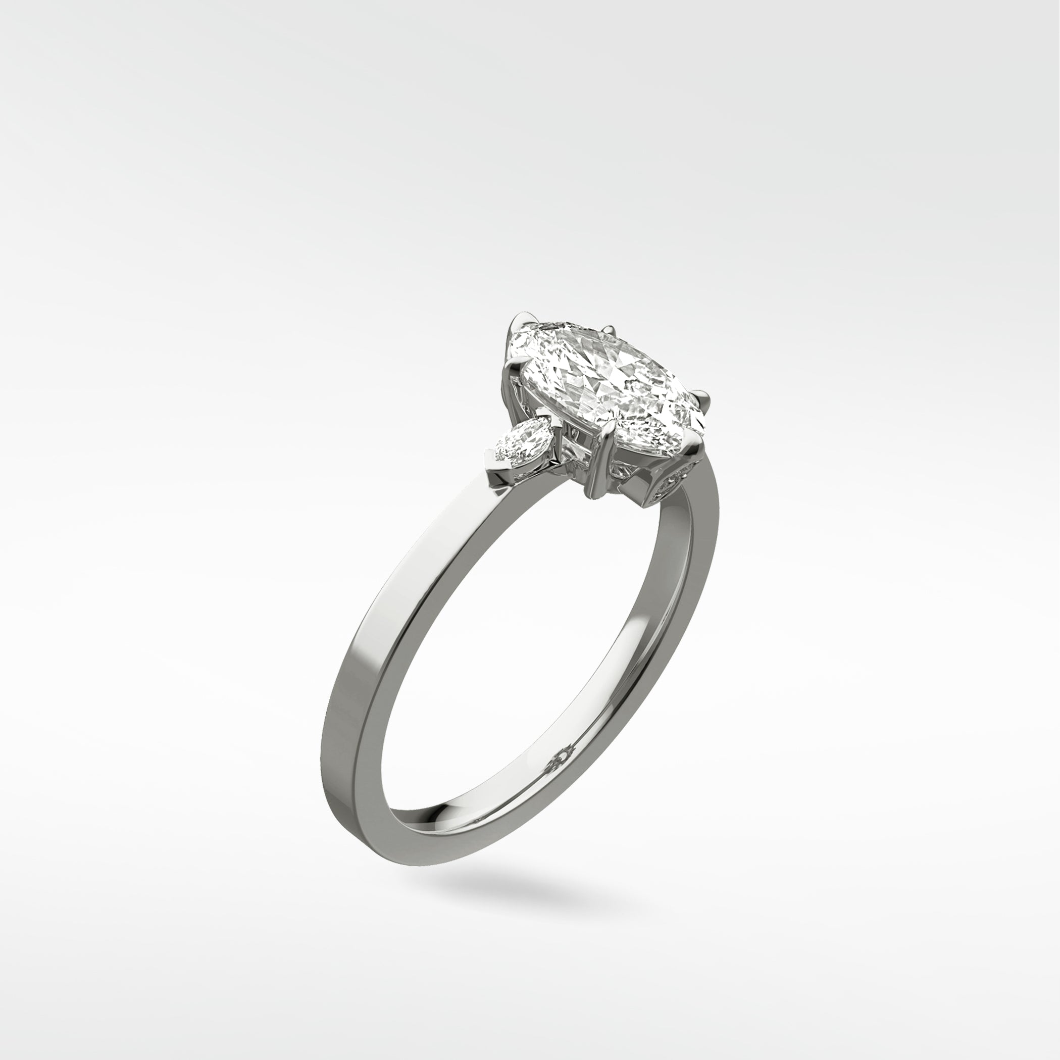 A three-stone Fern Engagement Ring featuring a marquise-cut diamond flanked by two smaller marquise diamonds on a platinum band.