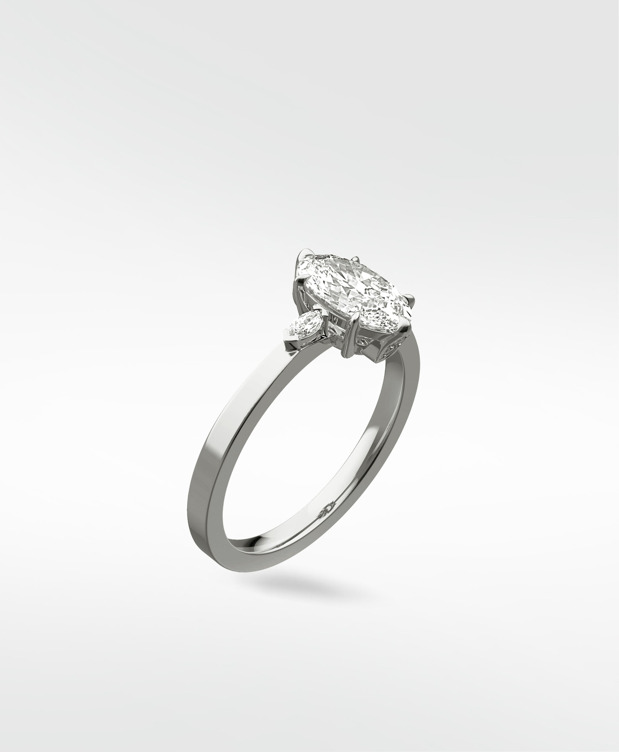 A three-stone Fern Engagement Ring featuring a marquise-cut diamond flanked by two smaller marquise diamonds on a platinum band.