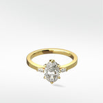 Lark & Berry's Fern Engagement Ring in yellow gold, featuring a central oval diamond with marquise accent diamonds on the side.