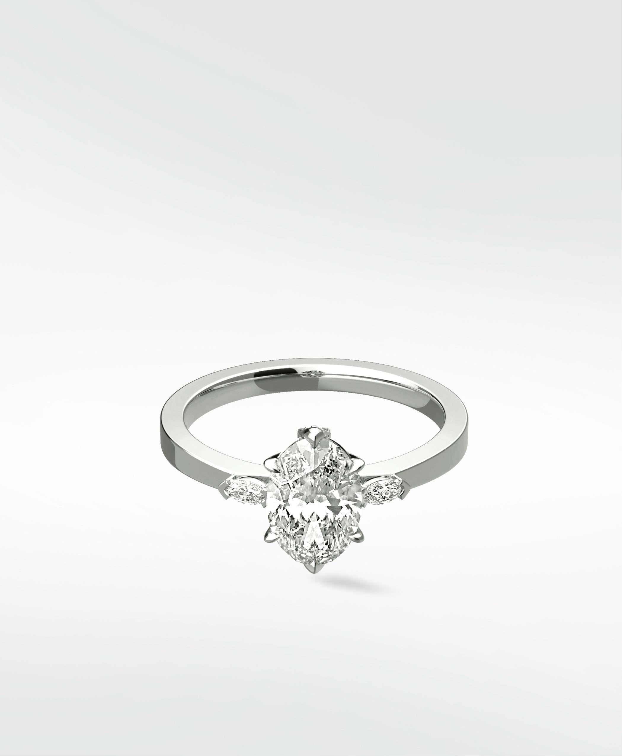 The Fern Engagement Ring with an oval diamond center stone and marquise accents on a platinum band.