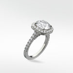 Angled view of the Sequoia Diamond Engagement Ring in platinum with a halo setting and a pavé diamond band against a white background.