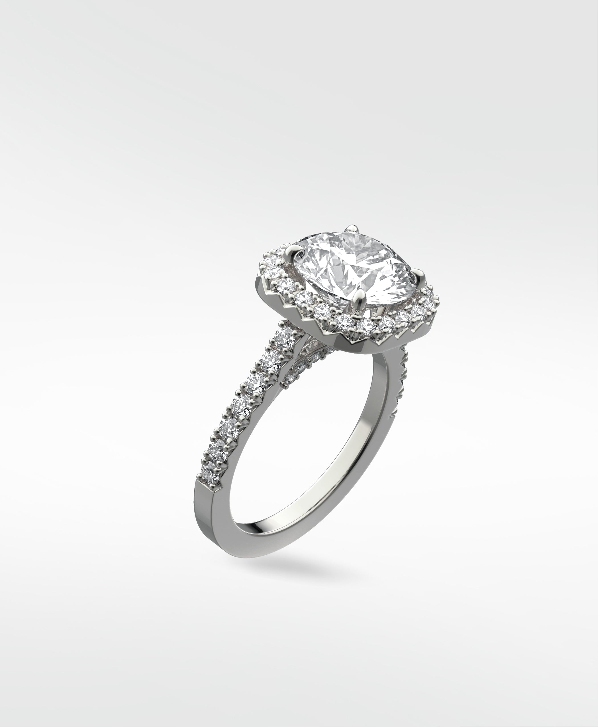 Angled view of the Sequoia Diamond Engagement Ring in platinum with a halo setting and a pavé diamond band against a white background.